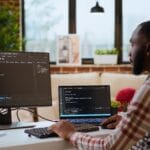 A web developer in Lagos working on his computer